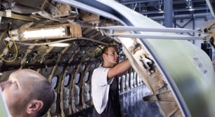 Photo of people repairing airplane cabin